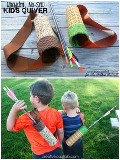 two young boys are making crafts out of paper and cardboard tubes, one is holding an umbrella