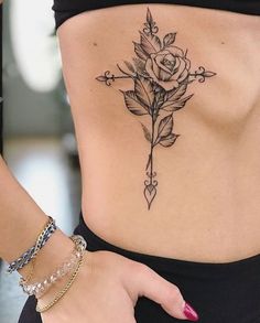 a woman with a rose tattoo on her stomach