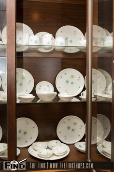 the china cabinet is filled with dishes and plates