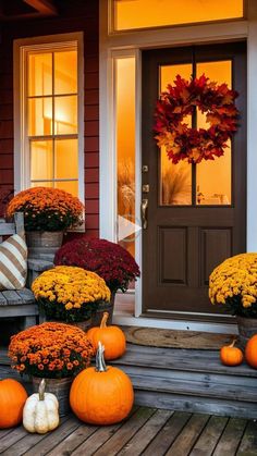 pumpkins and mumins sit on the front porch