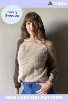 a woman standing in front of a white wall wearing a sweater and jeans with the text candy sweater free crochet pattern