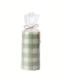 a roll of toilet paper wrapped in green and white checkerboard fabric with a bow