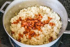 cooked rice and carrots in a pot on the stove