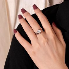 a woman's hand with a diamond ring on it