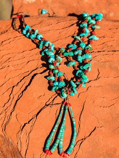 A traditional Pueblo jewelry adornment, a jacla is two loops of heishi that were originally earrings and sometimes fastened to the bottom of a stone necklace as a pendant-like attachment. Jacla is Navajo for “ear string”. Although jaclas are attributed to the Rio Grande Pueblo Indians, they were traded with other tribes so have become associated with the Navajo as well. In the oldest style necklaces, the jacla is a pair of loop earrings tied onto the necklace. The two loops would be removed from the necklace and used as earrings. This is how the jacla originated. I can just picture a pre-European-contact Rio Grande Puebloan taking his or her jewelry off and storing it that way. And sometimes when I not wanting to wear earrings, just leaving the jacla on the necklace as a pendant. The jacla Southwestern Style Adjustable Teardrop Necklace, Artisan Dangle Jewelry With Polished Beads, Bohemian Teardrop Necklace With Polished Beads, Bohemian Teardrop Necklaces With Polished Beads, Adjustable Southwestern Teardrop Jewelry, Southwestern Adjustable Teardrop Jewelry, Southwestern Necklace With Dangling Beads, Southwestern Beaded Lariat Jewelry, Turquoise Hand-strung Lariat Jewelry