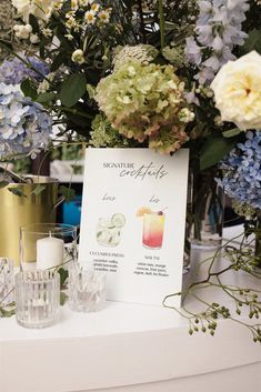 a table topped with lots of different types of flowers