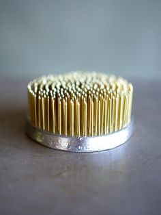 a close up of a brush on a table with some hair combs in it