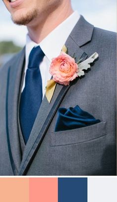 a man in a gray suit with a flower on his lapel