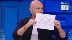 a bald man holding up a piece of paper with the word google written on it