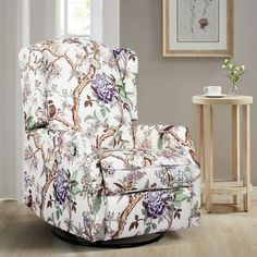 a living room with a floral chair and side table in it's center area