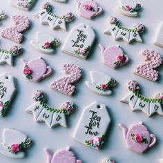 there are many decorated cookies that say tea time and have pink flowers on the top