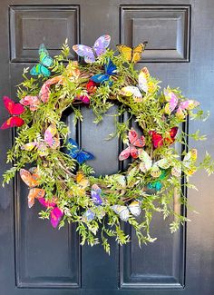 a wreath with colorful butterflies hanging on the front door