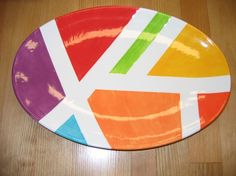 a multicolored plate with the flag of the united kingdom on it sitting on a wooden table