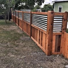 a wooden fence in front of a house