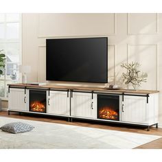 an entertainment center with fireplaces and a flat screen tv mounted on it's wall