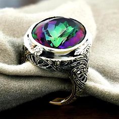 Discover the captivating allure of our Vintage Rainbow Mystic Quartz Filigree Ring, a stunning 13-carat piece that seamlessly blends timeless elegance with modern charm. Expertly crafted from solid 925 silver, this enchanting ring features intricately designed filigree work that showcases the shimmering spectrum of colors unique to the mystic quartz gemstone. Each piece is stamped with a 925 mark, ensuring you receive only the highest quality materials that stand the test of time. Perfect for birthdays or special occasions, this ring is more than just an accessory; it's a statement of individuality and style. Designed with both comfort and beauty in mind, the ring is available in multiple sizes to ensure a perfect fit. Whether worn alone or paired with other jewelry, it is sure to draw adm Mystic Quartz, The Mystic, Vintage Rainbow, Filigree Design, Filigree Ring, Quartz Ring, Solid 925 Sterling Silver, Beautiful Jewelry, Timeless Elegance