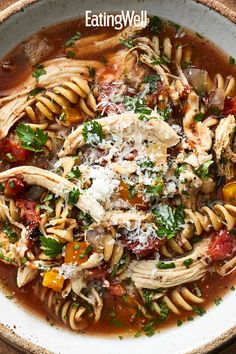 a white bowl filled with pasta and meat