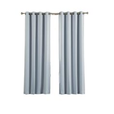 two white curtains hanging on the side of a window with metal rods and an eyelet