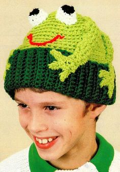 a young boy wearing a knitted frog hat