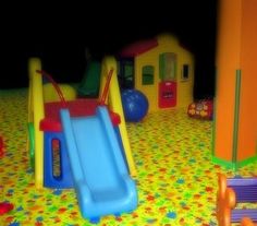 an indoor play area with toys and slides