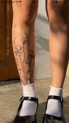 a woman's legs with tattoos on them