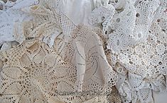 several pieces of white crochet lace are on display