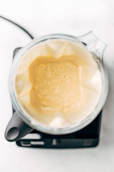 a blender filled with liquid sitting on top of a counter