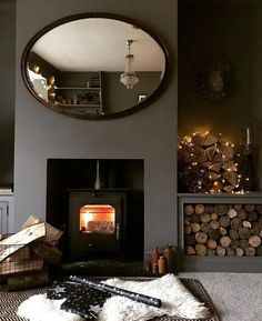 a living room filled with furniture and a fire place in the middle of it's fireplace