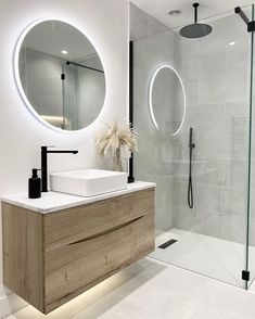 a bathroom with a sink, mirror and shower