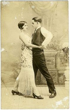 an old photo of a man and woman dressed in formal attire dancing the charleston swing