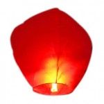 a red paper lantern is lit up on a white background with the light turned off