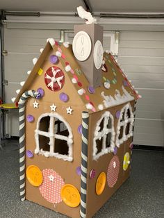 a cardboard gingerbread house with decorations on it