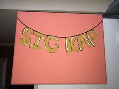 there is a pink and gold sign that says stig kar on it hanging from the wall