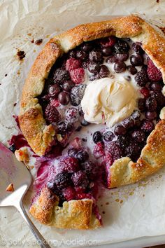 two pies with strawberries and blueberry filling on them