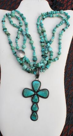 This is a stunning cross necklace. Two strands of various sizes and shapes of turquoise beads with a silver buffalo nickle attached to it. Large Navajo silver cross pendant with large teardrop shaped pieces of turquoise inlaid. Stamped G. Boyd Navajo silver. 14" necklace 4" long 2" wide pendant Bohemian Turquoise Cross Pendant Necklace, Necklace Cross, Silver Cross Pendant, Silver Cross, Turquoise Beads, Cross Pendant, Favorite Jewelry, Turquoise Necklace, Cross Necklace