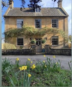 a house with yellow flowers in front of it