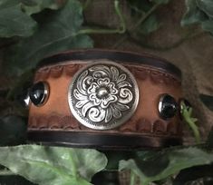 a brown leather bracelet with an intricate design