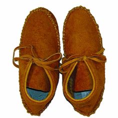 a pair of brown suede shoes with laces on the top and bottom part