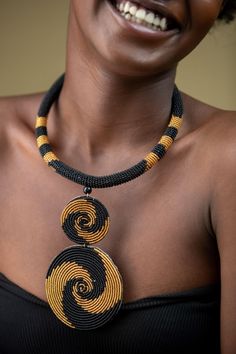 Unique African Maasai Handcrafted Beaded Necklace with an Elegant Look and Brilliant Finish. **GET FREE SHIPPING FOR ADDITIONAL ITEMS PURCHASED. Size(Around the Neck)-16 Inches. Color-Gold and Black. Get a pair of Matching Earrings and 2 Bracelets for an extra $7. Yes, Buy Multiple Items and pay shipping for 1 item only- The rest ships Free. (No Limits on the number of Multiple items). With a faster delivery time of 3 days via DHLExpress, Worldwide. Ordinary/Standard Shipping also available upon Artisan Black Necklace With Beaded Chain, Yellow Necklace With Round Black Beads, Unique Black Beaded Necklace, Artisan Black Beaded Chain, Unique Black Beaded Necklaces, Unique Statement Necklace, Woman Necklace, Cowrie Shell Necklace, Necklace African