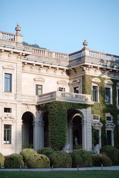 an old building with ivy growing on it's sides and balconies over the top