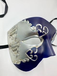 This is a stunning half face phantom masquerade mask with very venetian and phantom design embellishments, The mask has navy blue color in the middle decorated with distressed silver.It has a very elegant mysterious look. In my store I have other half face masquerade masks that you might like and laser cut masks with different colors and designs and different color of gems. I also have machine embroidered masquerade masks that color of threads and gems can be changed, I have masks with stick and Mascarade Mask Navy, Silver Masquerade Mask For Mardi Gras Theater, Silver Masks For Mardi Gras Theater, Silver Masks And Prosthetics For Mardi Gras Theater, Silver Eye Mask For Theater, Silver Theater Eye Mask, Silver Masks And Prosthetics For Theater And Carnival, Silver Theater Mask For Carnival, Blue Halloween Masquerade Mask