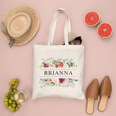 a personalized tote bag surrounded by grapefruits, straw hat and sunglasses