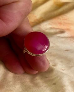 FANTASTIC FIND! Beautiful round agate that has one of the most unique color translucent stunning apricot rose. You won't find many rings with this kind of color. Almost as if this ring was in the family of the labradorite or moonstone because of the incredible sheen. There is no scratches or chips on this stone whatsoever. The metal sterling silver plated and is stamped '925' and has a copper base. My three girls and my wife this this is one of the most beautiful agate rings they have seen, so as you can imagine, I had a difficult time putting it up for sale. SIZE: 8.25 Pink Cabochon Ruby Ring, Pink Round Cabochon Ruby Ring, Pink Cabochon Ruby Ring Gift, Many Rings, Agate Rings, Three Girls, Comme Si, Kinds Of Colors, Agate Ring