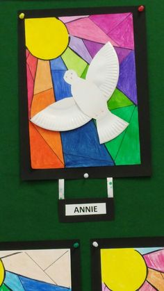 paper plate doves are displayed in front of the nameplate for an art project