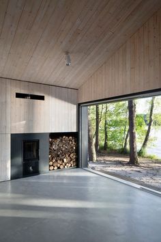 an empty living room with wood and glass doors leading to the outside area, along with a fireplace