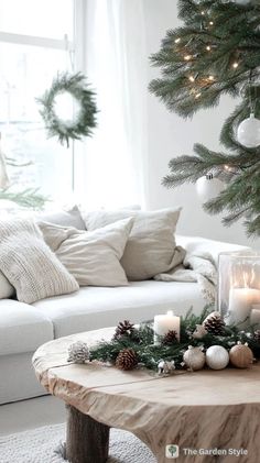 a living room decorated for christmas with candles and wreaths on the coffee table in front of the couch