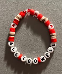 a red and white beaded bracelet with the word halloween spelled in small letters on it