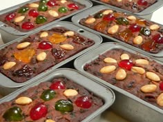 six muffins with fruit toppings in tins on a counter top, ready to be eaten