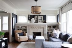 a living room filled with furniture and a fire place