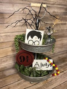 two tiered metal trays holding harry potter themed items, with tree branches in the center